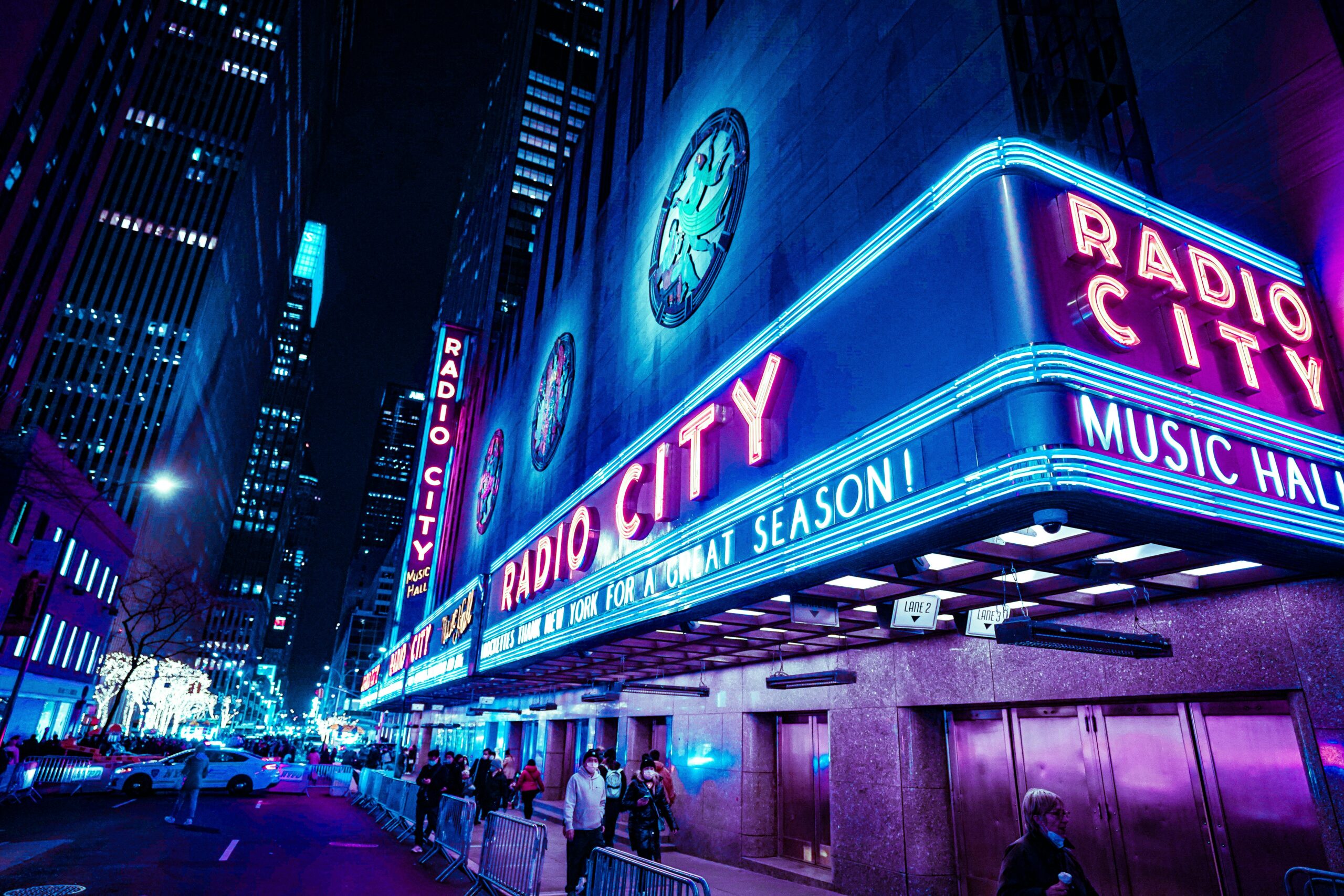 Iconic Radio City Music Hall with neon lights at night in New York City.